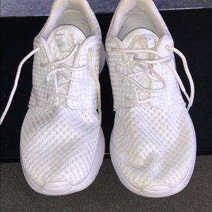 White and silver Nike Roshes